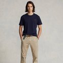 Model in donkerblauw Polo Ralph Lauren T-shirt, beige broek en riem, volledig zicht.