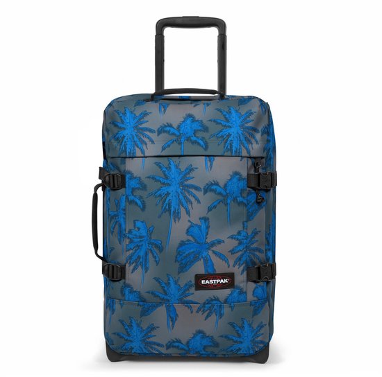 Grijze koffer met een print van blauwe palmbladeren, zwarte handgrepen en wielen.