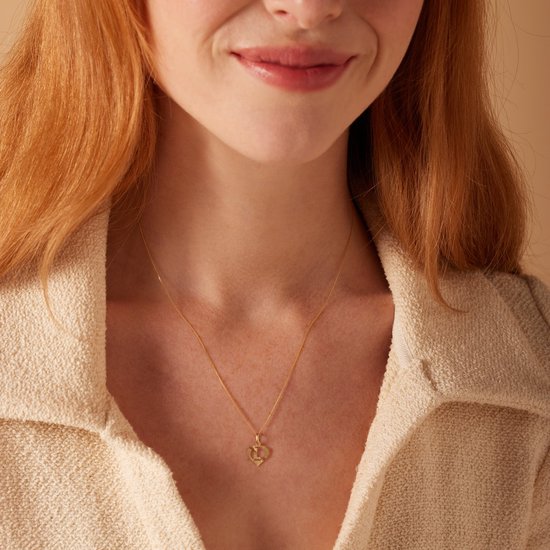 Gouden ketting met hartvormige hanger met de letter B.