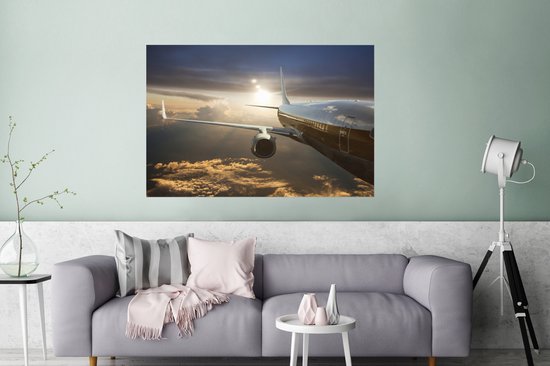 Un avion à réaction survole les nuages Poster 120x80 cm - Tirage photo sur Poster (décoration murale salon / chambre)