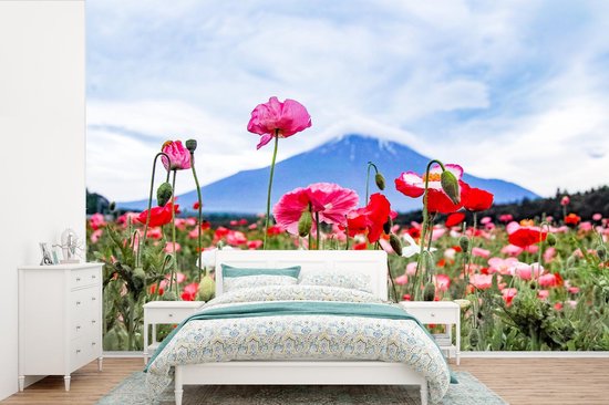 Behang - Fotobehang Roze papavers voor een berg - Breedte 450 cm x hoogte 300 cm