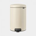 Crèmekleurige Brabantia NewIcon prullenbak met een zwart voetpedaal, op een grijze achtergrond.