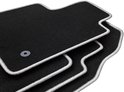 Tapis de sol noirs empilés avec passepoil gris et un œillet de fixation gris.