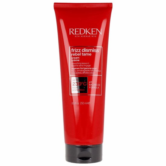 Een rode tube met witte en gouden tekst, waaronder 'REDKEN frizz dismiss rebel tame cream crème', 'up to 230°C heat protection'.