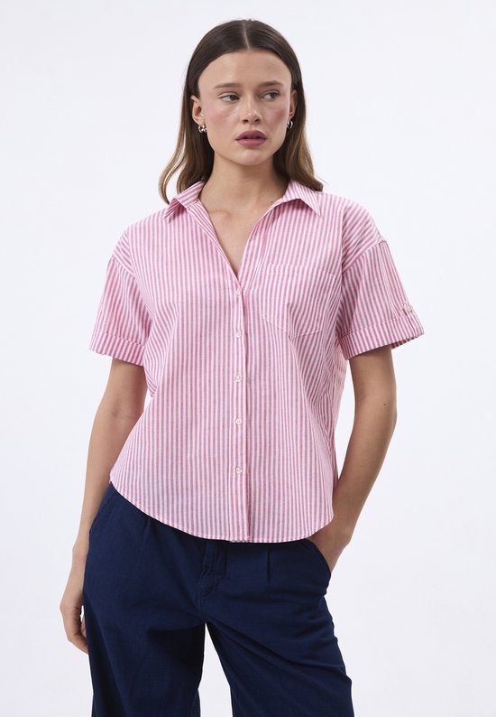 Chemise pour femme à manches courtes, rose à rayures blanches. Mannequin porte la chemise avec les mains dans les poches.
