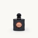 Zwarte Yves Saint Laurent Black Opium parfumfles met glitterafwerking en goudkleurige tekst.