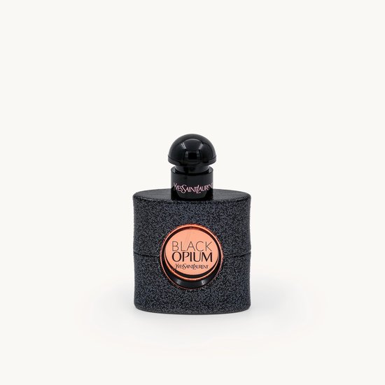Zwarte Yves Saint Laurent Black Opium parfumfles met glitterafwerking en goudkleurige tekst.