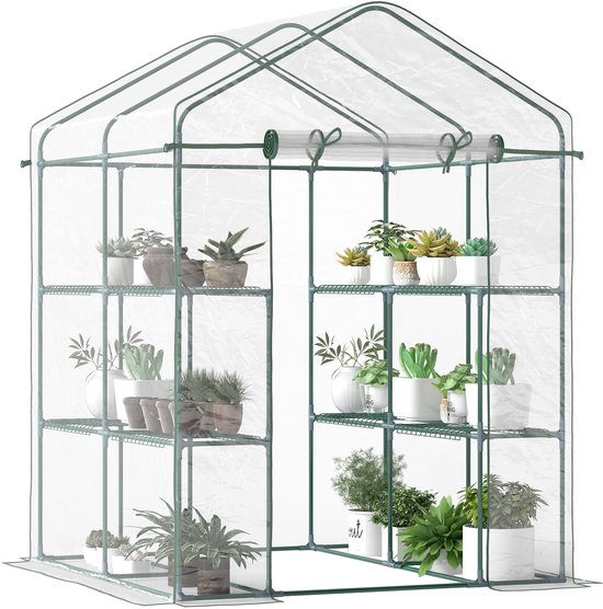 Transparante kas met groen frame, gevuld met diverse planten op de schappen.