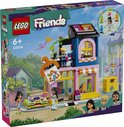 Magasin de vêtements vintage LEGO Friends avec trois figurines : Liann, Jordin et Olly. Le magasin a une façade jaune avec un auvent rose et des décorations.
