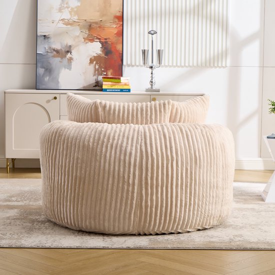 Ronde beige fluwelen loungestoel met ribbelstructuur, in een woonkamer.