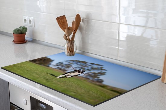 KitchenYeah® Inductie beschermer 81x52 cm - Een border collie met een stok in de mond - Kookplaataccessoires - Afdekplaat voor kookplaat - Inductiebeschermer - Inductiemat - Inductieplaat mat