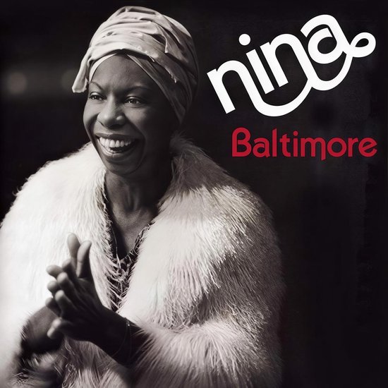 Nina Simone lacht in een witte bontjas met een hoofddoek. "nina Baltimore" staat rechtsboven.