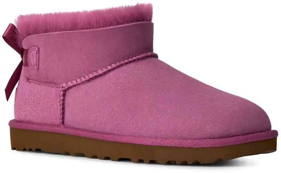 Paarse UGG laars met roze strik op de achterkant, bruine zool.