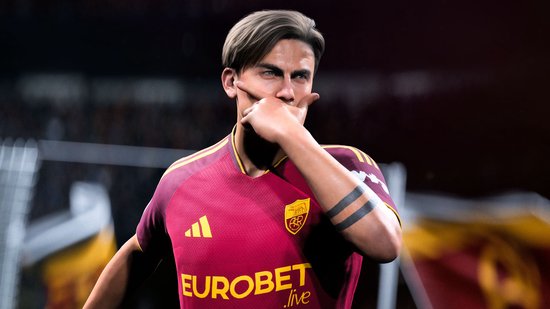 Voetballer in rood shirt met EUROBET logo op de borst en tatoeages op de arm.
