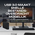 Disque dur externe noir à côté d'un ordinateur, se connecte via USB 3.0 pour un transfert de fichiers rapide.