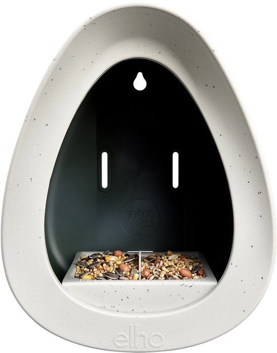 Witte vogelvoerder met vogelzaad op de bodemplaat. Met logo 'elho'.