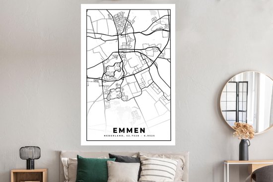 Affiche carte d'Emmen en noir et blanc, au-dessus d'un lit avec des coussins gris et verts.
