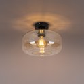 Amberkleurige glazen plafondlamp met een zwarte basis, verlicht met een peertje.