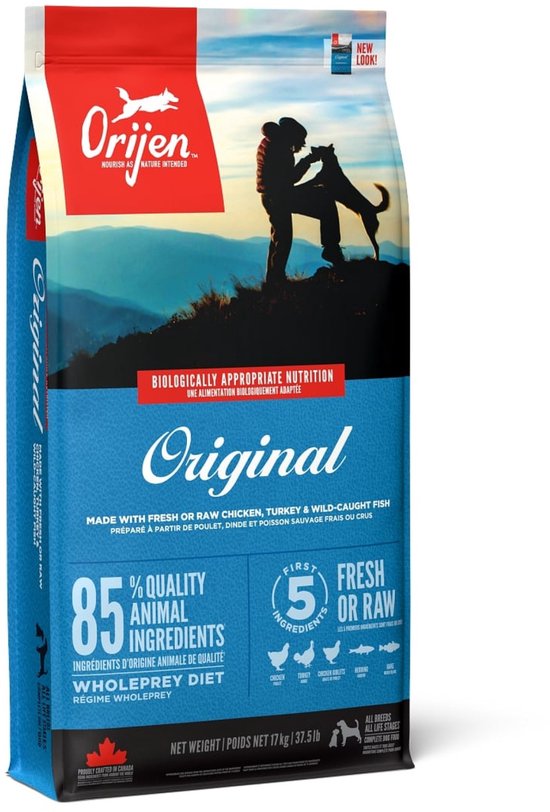 Orijen Original hondenvoer verpakking, met een silhouet van een persoon en hond tegen een berglandschap.