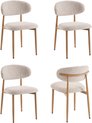 Quatre chaises de salle à manger beiges avec assise et dossier en tissu, et pieds en bois.