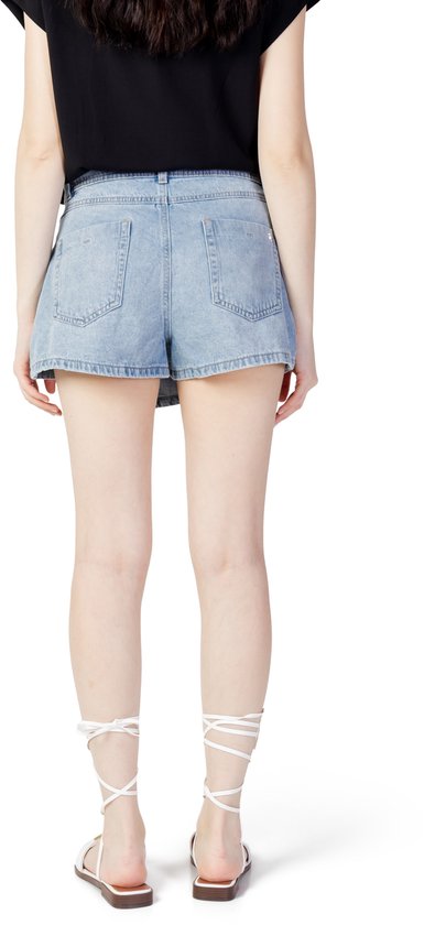 Model met de rug naar voren in een lichtblauwe denim skort.