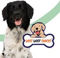 Vrolijke zwarte en witte hond kijkt naar de camera, naast een botvormig logo met "WOEF WOEF SNACKS".
