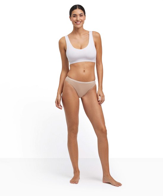 Model in wit Falke bralette en beige slipje met logo band.