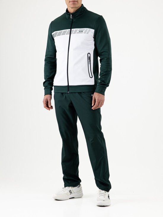 Donkergroen trainingsjack met witte baan, ritssluiting en zakken, op een model met bijpassende broek.