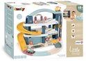 Doos van een Little Smoby garage met gele glijbaan, auto's en een helikopter. "Grand garage Big garage".