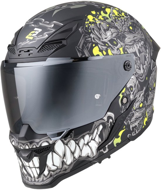Casque de moto noir avec impression graphique monstrueuse grise et jaune, chaînes et crâne sur le menton.
