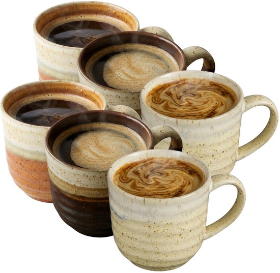 Vijf aardewerken mokken in verschillende bruin-crèmekleuren, gevuld met koffie.