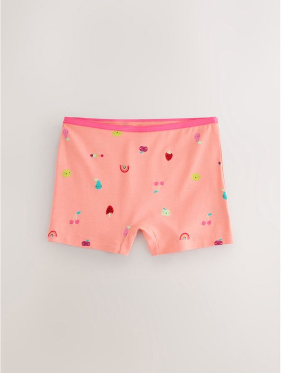 Oranje boxershorts met een all-over patroon van diverse fruitjes, regenbogen en gezichtjes, met een roze boord.