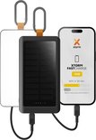 Zwarte Xtorm powerbank met zonnepaneel, aangesloten op een smartphone die 15W fast charge oplaadt.