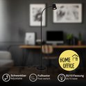 Zwarte staande lamp met verstelbare arm en voetbediening, geschikt voor thuiskantoor.