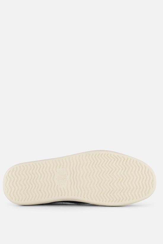 Semelle d'un mocassin HEYDUDE bleu marine avec profil en zigzag.