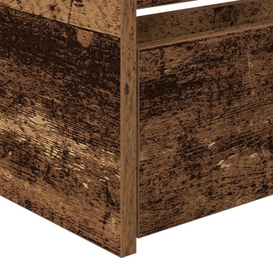 Detail van de hoek van een bedframe in verweerd hout met zichtbare planken.