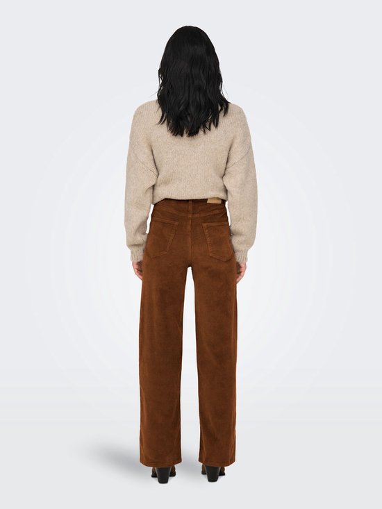 Model van achteren gezien in bruine corduroy broek met wijde pijpen en beige trui.