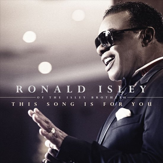 Ronald Isley van The Isley Brothers met zonnebril, smoking en strikje. Titel: This Song Is For You.