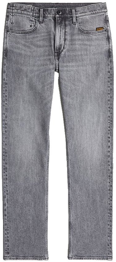 Rechte grijze jeans met een lichte wassing en een kleine gele patch op de rechterzak.