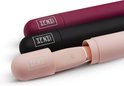 Drie vibrators in roze, zwart en bordeauxrood, deels in hun hoesjes.