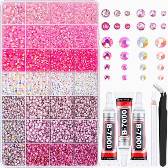 Roze en witte strass steentjes in bakjes, met lijmflacons en pincet.