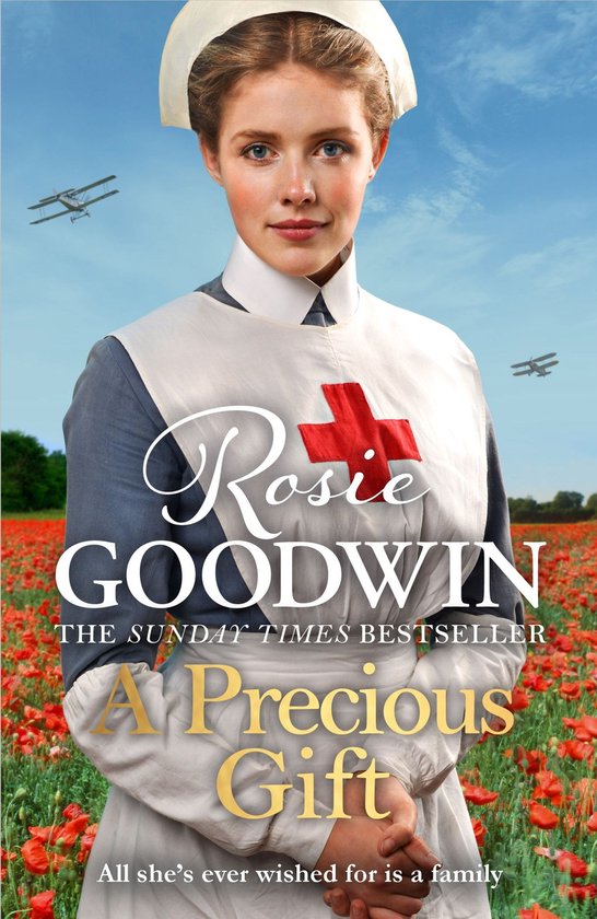 Een verpleegster in een rode kruisuniform staat in een veld vol klaprozen. Rosie GOODWIN. A Precious Gift.