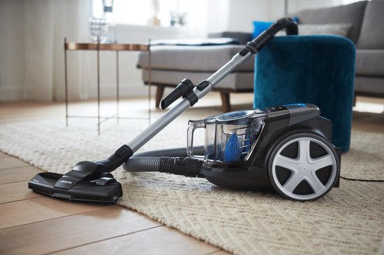 Aspirateur Philips noir série 3000 sur un tapis dans un salon.