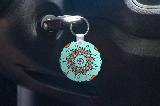 Porte-clés - motif sur fond bleu clair avec une fleur orange et des décorations - Plastique - Rond