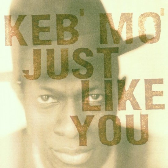 Close-up van Keb' Mo', met de titel 'Keb' Mo' Just Like You' eroverheen gedrukt.