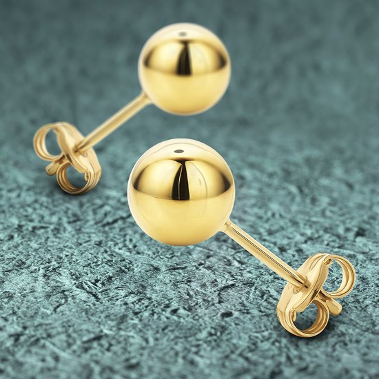 Twee gouden knopoorbellen met postsluiting op een turquoise achtergrond.