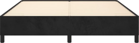 Zwart boxspringbed met houten lattenbodem en korte zwarte pootjes.