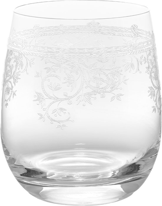 Un verre transparent avec un motif décoratif gravé complexe autour du dessus.
