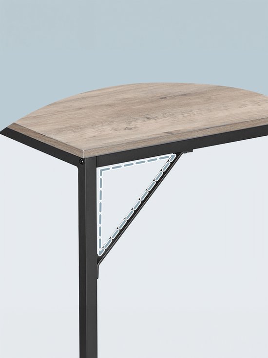 Bureau met een lichtbruin houten blad en een zwart metalen frame. Close-up van een versteviging aan de hoek.