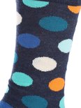 Detail van een donkerblauwe Happy Socks met grote turquoise, blauwe, witte en oranje stippen.